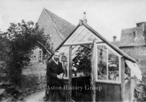 Old photograph taken in 1905 of Aston school teacher Mr Nudds outside his greenhouse.