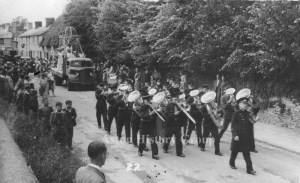 July 1949, British Legion Carnival parade along High Street Aston, with a band playing and floats following behind.