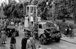 The 1953 Coronation parade with a float and people following, along High Street, Aston.