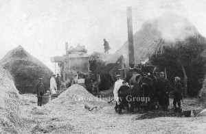 Farming, old photo of threshing with a steam engine.